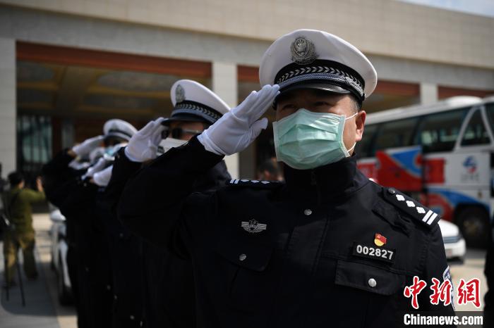 圖為交警們向醫(yī)療隊(duì)敬禮?！】灯?攝